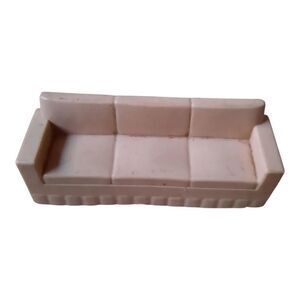 Marx hard plastic dollhouse sofa in a pale pink color. 
